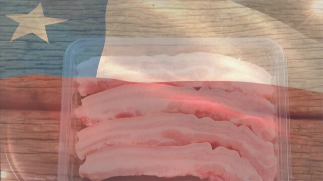Flag drifting across wood plank, shifting highlights and revealing plastic bacon tray for showcase