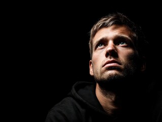 Fototapeta premium person looking determined forward isolated on a black background