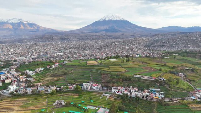 Aerial view of the Misti volcano during the rainy season with the Paucarpata terraces in Arequipa, Peru