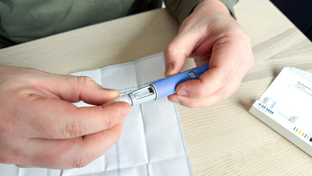 Crafting precision with insulin pen, meticulous care in health ritual, Diwali wellness, diabetes awareness, Caucasian male focus