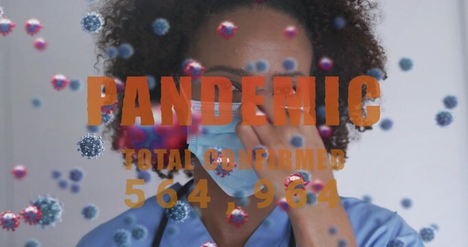 Adjusting nurse touching mask in clinic, blue scrubs with stethoscope, PANDEMIC TOTAL 564,964 virus