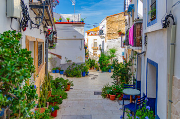 Fototapeta premium Alicante old town Barrio de Santa Cruz neighborhood with Calle San Rafael narrow street steep stairs, typical white houses, traditional colorful buildings in Alicante city historic centre, Spain