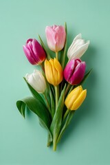 Obraz premium Fresh Spring Tulips Arrangement on Soft Green Backdrop with Space for Text