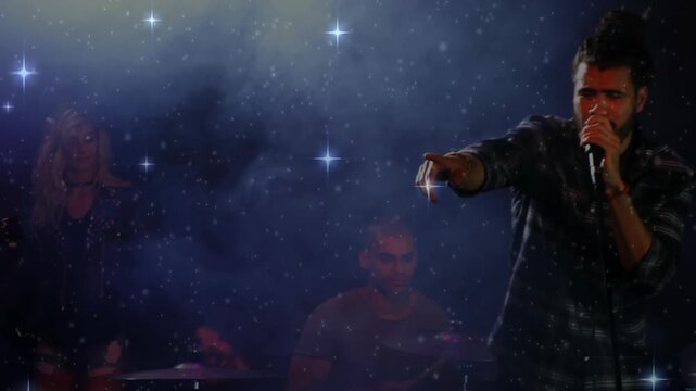 Lead singer stepping in on music cue, pointing, clasping mic, singing vocal line under star overlay