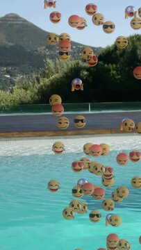 Vertical video: Emoji spheres spawning above pool cascading into water, forming playful overlay