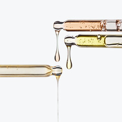 Three pipettes different droppers with a cosmetic product serum or ampoule or oil drips from three. Square shaped frame mock up empty space