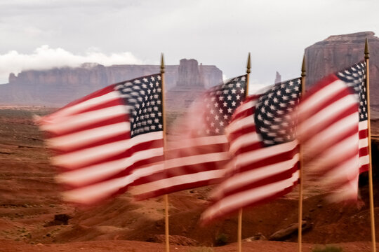 Monument Valley, Utah, USA.American flags blowing in the wind. Motion blur image