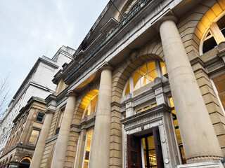 Naklejka premium Elegant neoclassical building facade with tall columns in Manchester UK at street level