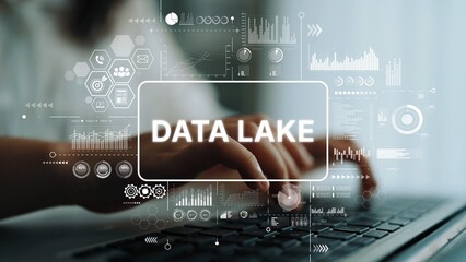 Hands Typing on Keyboard with Data Lake Concept and Data Visualizations Overlaid in a Modern Office...