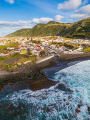 Aerial view of the black sand beach at Praia dos Moinhos and the coastal village of Porto Formoso in S&atilde;o Miguel, Azores, Portugal