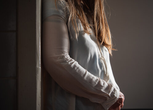 Woman standing in doorway of home