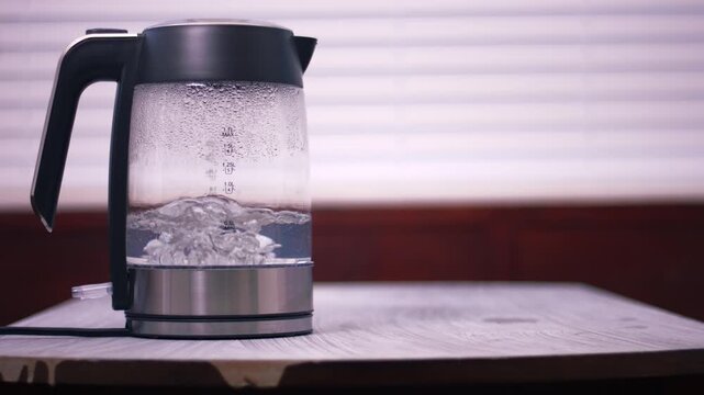 Hot water boiling in glass kettle