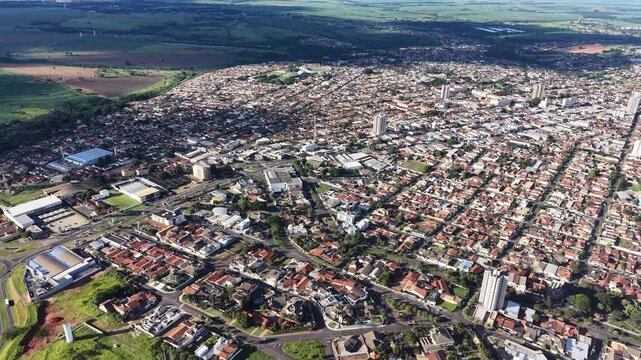 Aerial video footage of a sprawling city with a mix of urban and natural landscapes