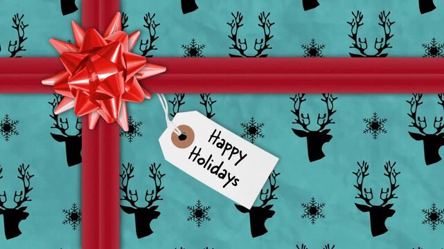 Animation of happy holidays text on tag over christmas present with red ribbon