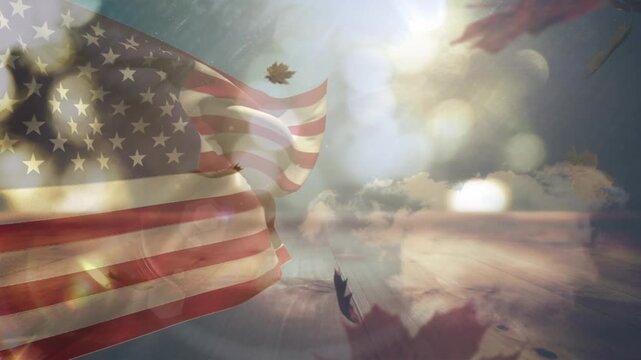Composite of waving american flag over spots of light against maple leaves falling and blue sky