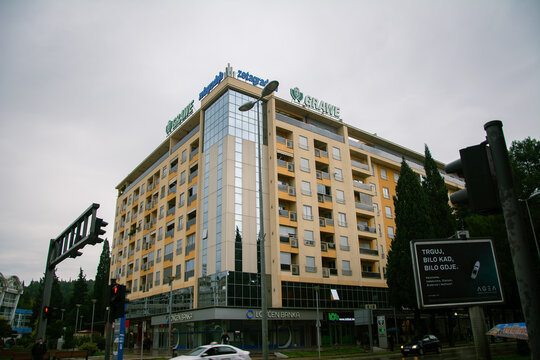 Podgorica, Montenegro &ndash; November 12, 2019: Residential and commercial building with Grawe signage and Lovćen Banka branch on ground floor at a city intersection.