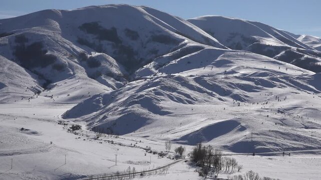 Snowy winter landscape in rural Anatolia Turkey with mountains plains and village scenery. Cold season countryside creates a calm background across snowy mountain plains and villages.