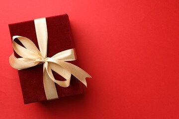 Beautiful velvet gift box on red background, top view. Space for text