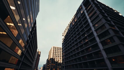 Naklejka premium concrete canyon under golden light with repetitive balconies and deep perspective, brutalist geometry and strong shadow contrast, cinematic urban vista