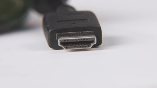 Close up slow motion with soft focus background plate blur of black hdmi port cable for 4k high definition video support on tech store and living room tv television cables cabling with lens flare
