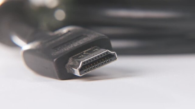 Close up slow motion with soft focus background plate blur of black hdmi port cable for 4k high definition video support on tech store and living room tv television cables cabling with lens flare