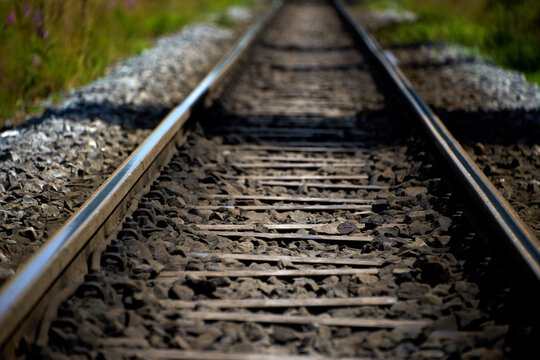 Long Railway Tracks Leading into the Distance on a Sunny Day