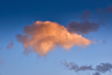 Vibrant Golden Cloud Against Blue Sky at Sunset