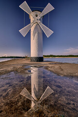 Fototapeta premium Stawa Mlyny Windmill Lighthouse Reflected on a Pier in Swinoujscie, Poland