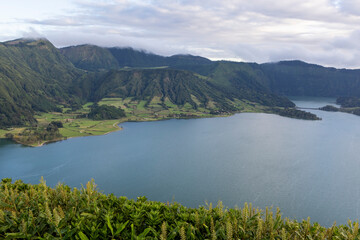 Fototapeta premium A beautiful lake with mountains in the background at Sete Cidades, Azores.