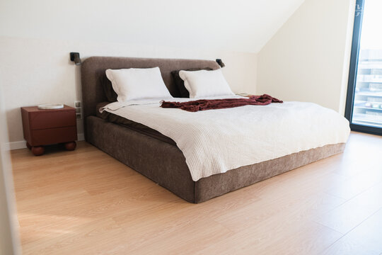 Modern Double Bed with White Linens in a Minimalist Attic Bedroom