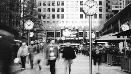 Busy Urban Plaza with Multiple Clocks and Pedestrians in Motion, Black and White © The Willography