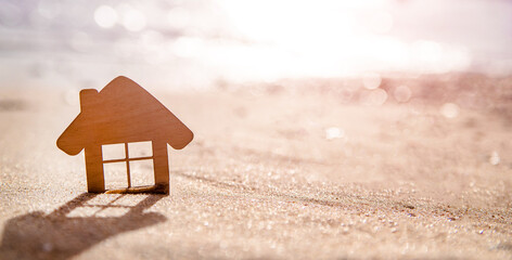 The symbol of the house standing on the seashore
