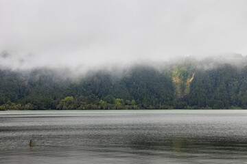 A body of water with a cloudy sky above it