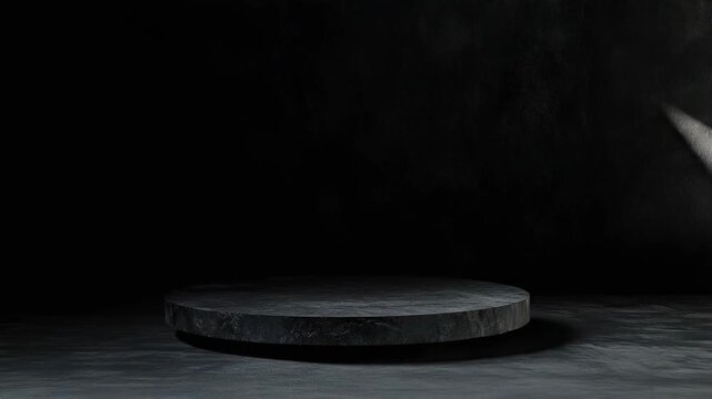 Dark gray concrete room featuring a circular rock stage, with a beam of natural light creating strong contrast and shadows on the rough textured wall and floor surface