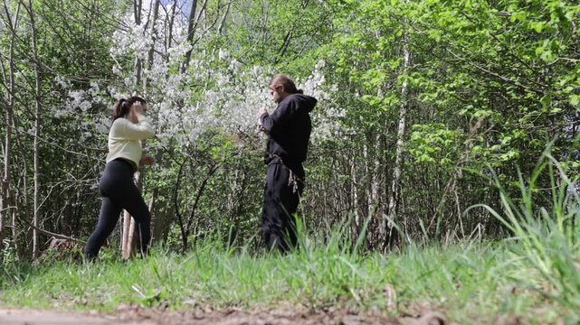 a young couple in love walking through a blooming spring park