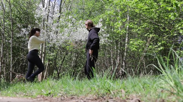 a young couple in love walking through a blooming spring park