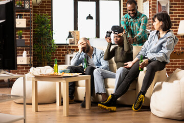 Black woman removes VR glasses, looking confused at TV screen after losing video game. African...