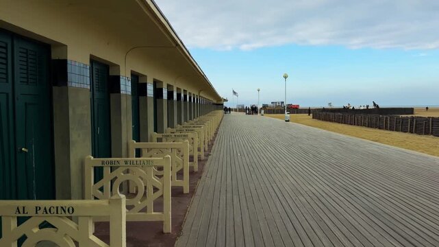 Changing booths bearing the names of Hollywood actors line the boardwalk promenade Les Planches in Deauville, France, October 20, 2025. High quality 4k footage