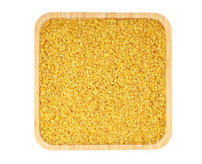 Bulgur grain in bamboo plate, flat lay