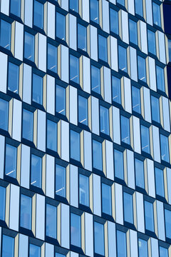 Modern office facade of windows forming abstract pattern with geometry and symmetry in architecture building detail for minimal corporate design