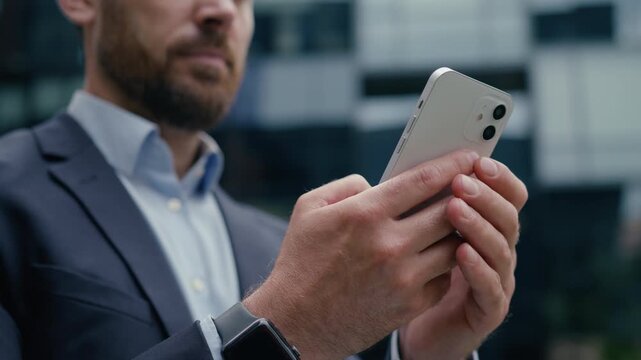 Caucasian businessman using mobile phone smartphone typing message city outdoor gadget hands man business client employer male office guy developer entrepreneur cellphone internet connections street