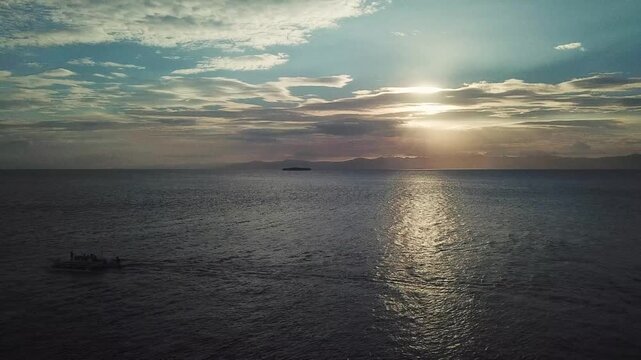 Drone view of traditional Filipino boat at sunset in Moalboal, Cebu, Philippines