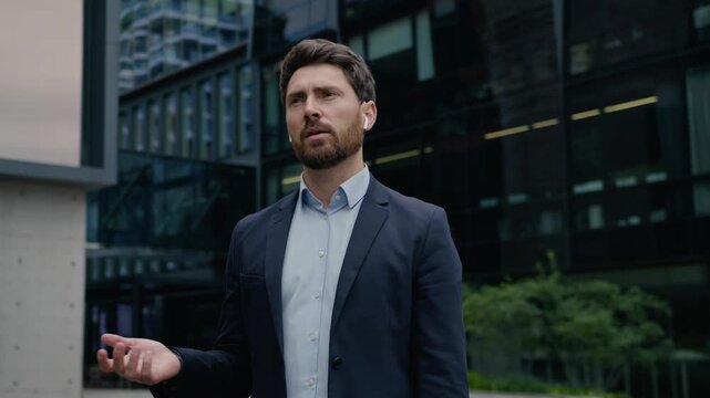 Professional businessman Caucasian man leader in city talk phone earphones call guy male entrepreneur business coach developer real estate agent manager distant communication mobile downtown outdoors