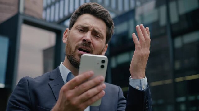 Upset sad man Caucasian businessman using mobile phone in city fail lose message guy male entrepreneur business client outside smartphone worried frustrated online gambling app problem stress outdoors