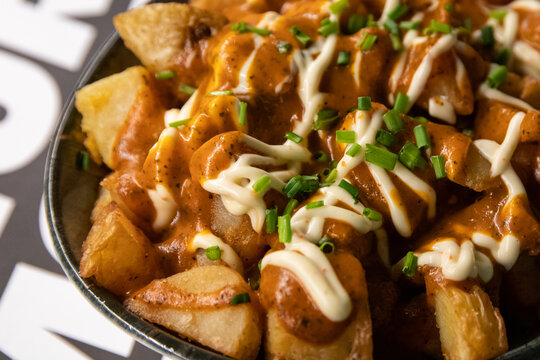 Patatas bravas in bowl with copy space and soft background