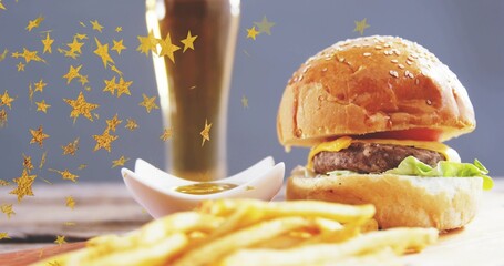 Showcasing sesame bun cheeseburger sitting on studio board with fries, sauce, confetti, copy space