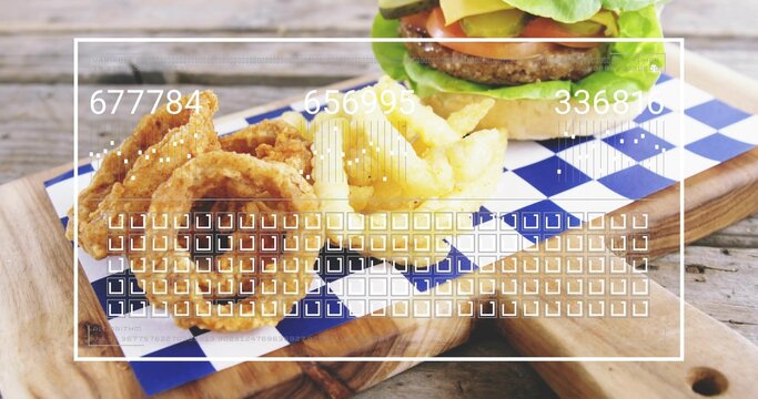 Displaying beef burger, onion rings and fries on cutting board on rustic table with UI overlay
