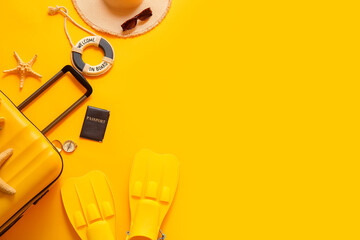 Composition with suitcase, passport, flippers and beach accessories on yellow background, closeup © Pixel-Shot