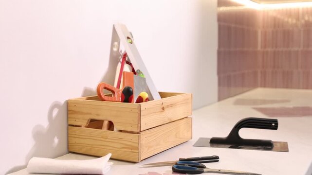 Stylish peel and stick tiles on wall and tools in kitchen