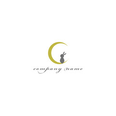 Obraz premium Cute Rabbit Sitting on Crescent Moon Logo Icon in Yellow and Gray